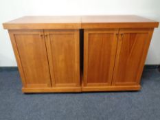 A pair of contemporary double door side cabinets in a walnut finish
