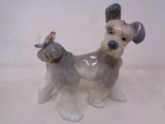 A Lladro figure of a terrier with bird.