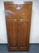 An Edwardian oak double door wardrobe
