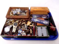 A tray of wristwatches, pen knife, wooden crucifix on bead necklace, cast metal crucifix, pipe,