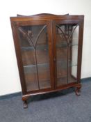 A 20th century mahogany bow fronted glazed display cabinet