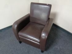 A brown faux leather club armchair
