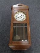 An Edwardian oak cased 8-day wall clock with silvered dial