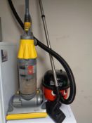 A Dyson DC 07 vacuum together with a Henry vacuum