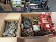 A box of Hornby Dublo track, power control units, Piko wagon, miniature figures, vintage Lurpak box,