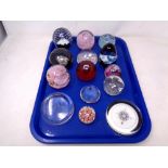 A tray of fourteen assorted glass paperweights