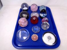 A tray of fourteen assorted glass paperweights