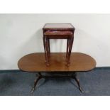An oval inlaid mahogany coffee table and a nest of two tables