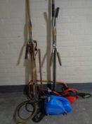 A pressure washer and assorted garden tools,