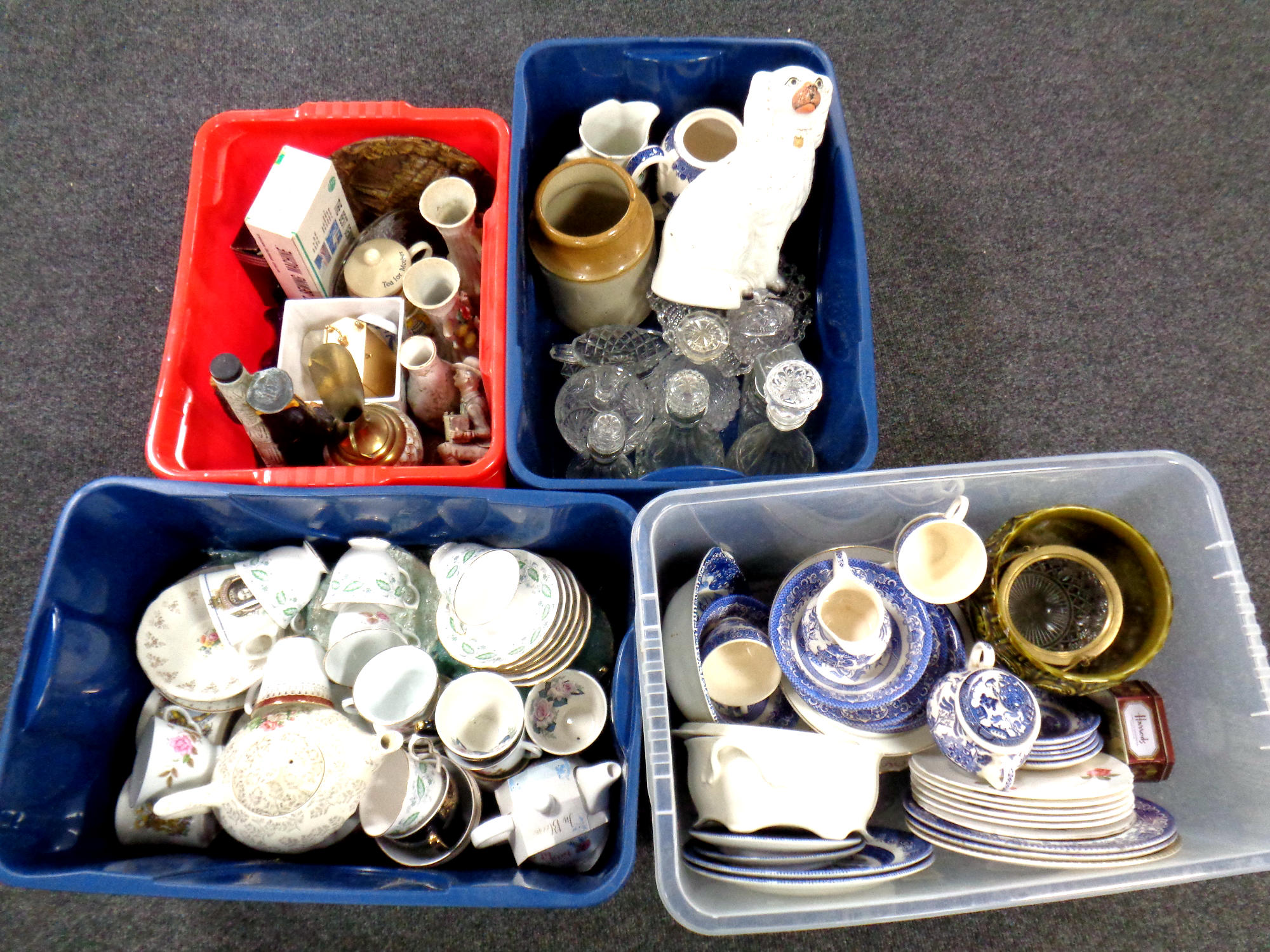 Four crates of assorted pressed glass and ceramics, part English tea services,