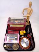 A tray of boxed Corgi die cast trams, dominoes, graduated brass weights, barometer,