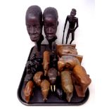 A tray of carved hardwood tourist pieces, book end, ornaments,