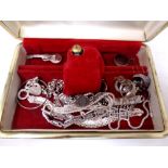 A jewellery box containing silver jewellery including bracelets, coin bracelet, rings,