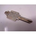 A solid silver door key