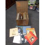 A plywood crate containing vinyl LP's and seven inch singles,