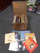 A plywood crate containing vinyl LP's and seven inch singles,