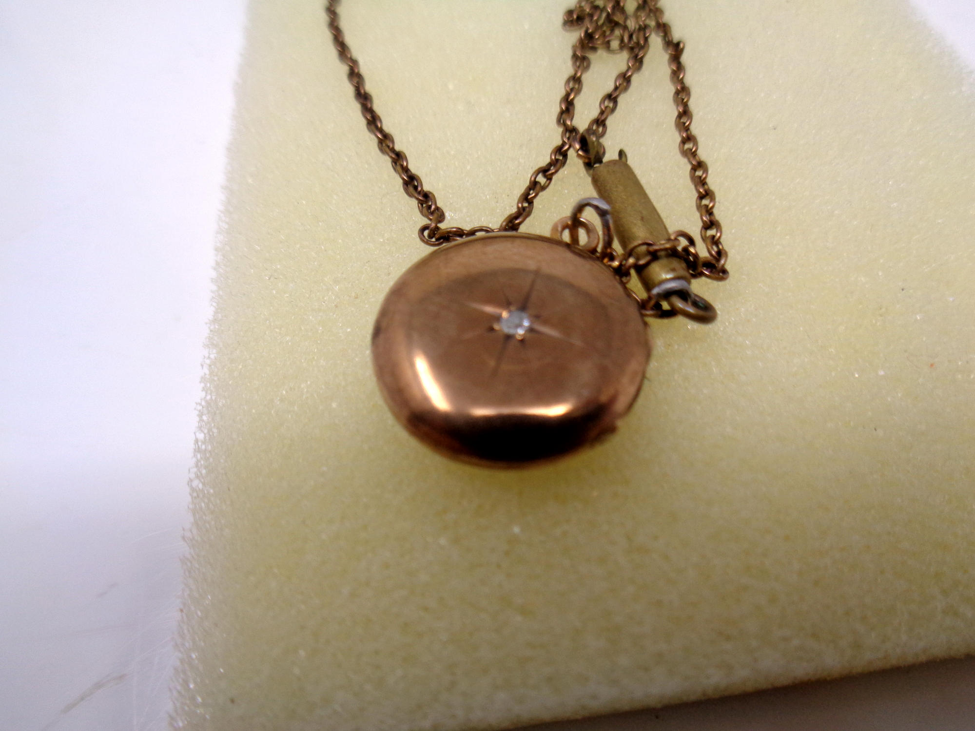 A late 19th century 9ct gold locket, with small round old cut diamond to centre, - Image 2 of 2