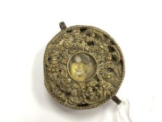 A Tibetan circular brass prayer box, diameter 6cm.