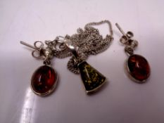 An amber pendant with chain and earrings