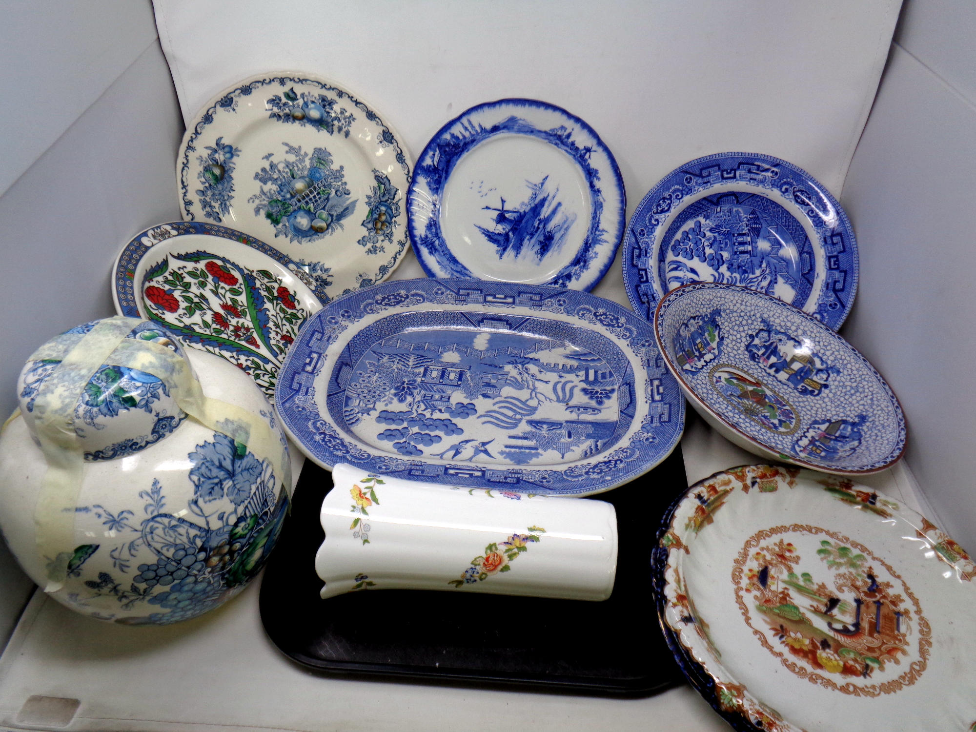 An antique transfer printed blue and white meat plate, further willow pattern plates,