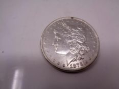 A silver American dollar brooch