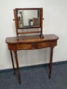 A serpentine front two drawer mahogany hall table and a small mirror