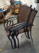 A set of four metal framed rattan armchairs