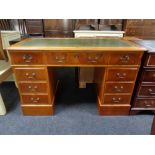 A yew wood twin pedestal desk fitted nine drawers,