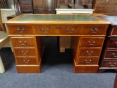 A yew wood twin pedestal desk fitted nine drawers,