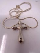 A sterling silver cross pendant on chain
