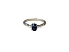 A platinum sapphire and diamond three stone ring, size L.