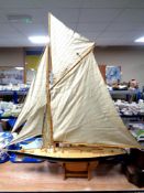 A large wooden pond yacht on stand, length 114 cm.