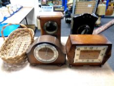 A box of four various mantel clocks and wicker basket
