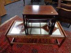 A 20th century teak tiled coffee table with undershelf together with a nest of two tables