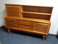 A 20th century teak sideboard fitted with drawers and cupboards