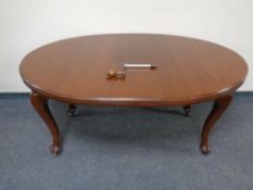 A mahogany extending oval dining table together with set of four stained pine dining chairs