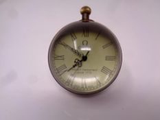 A reproduction "Omega" paperweight desk clock.