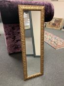 An ornate golden framed mirror