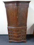 A mahogany serpentine front cabinet fitted with four drawers beneath