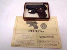 A German Perfecta starting pistol with tin of caps