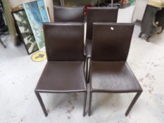 Four brown vinyl upholstered dining chairs