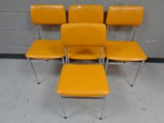 Four chrome framed dining chairs upholstered in orange vinyl