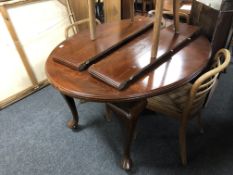 A stained beech extending oval dining table