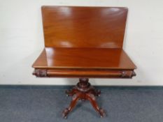 A mahogany tea table on carved pedestal base