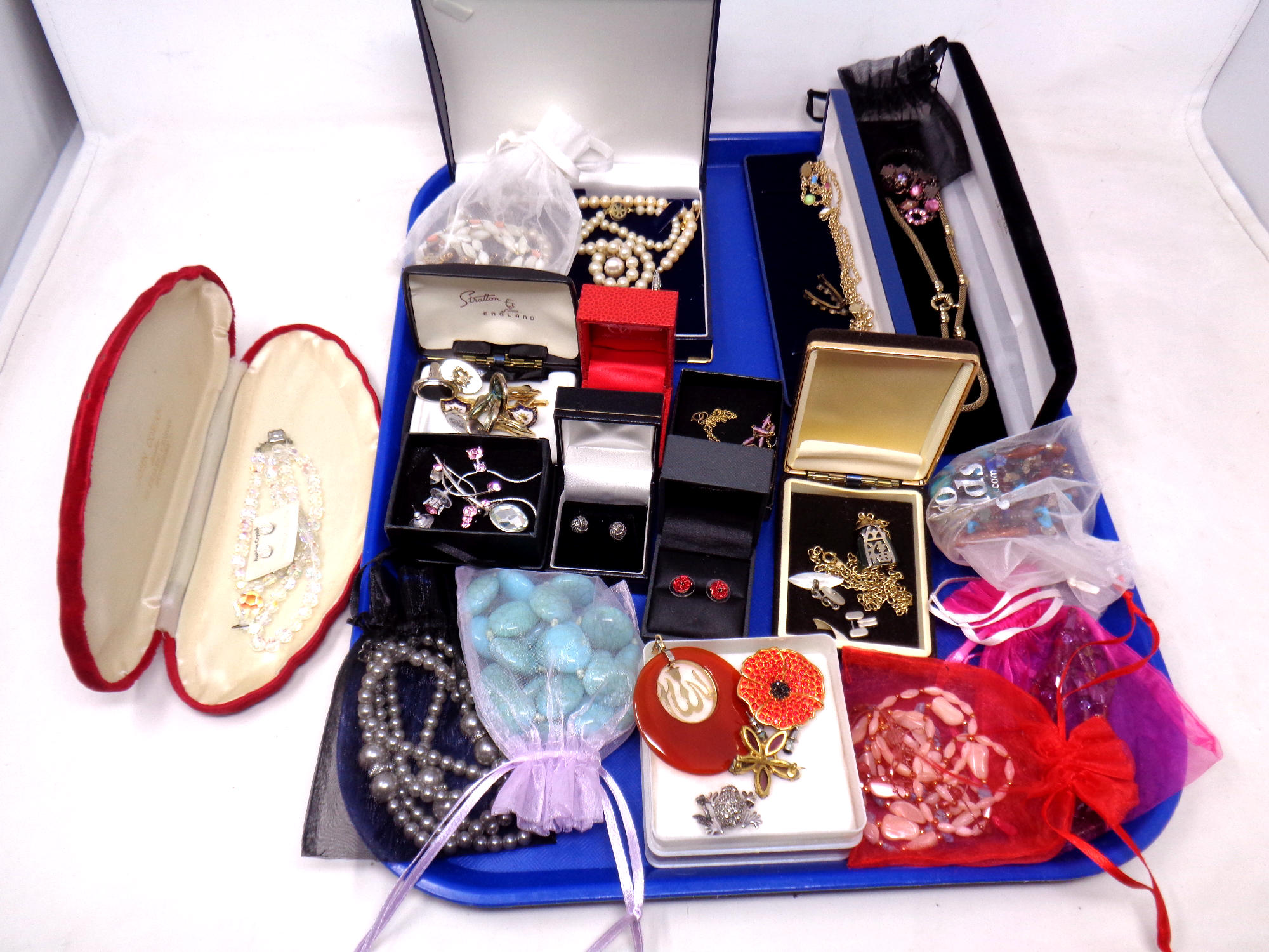 A tray of costume jewellery including earrings, pendants, simulated pearls,