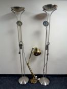 A pair of up lighters and a brass angle poised lamp