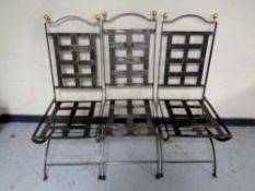 A set of six wrought metal dining chairs
