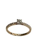 A 9ct solitaire diamond ring, set with diamond shoulders, approximately 0.3ct.