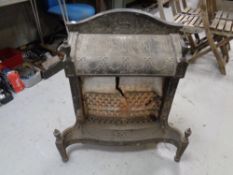 An antique cast iron gas fire insert