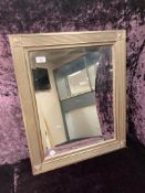 A contemporary mirror in ribbed frame 53 cm x 53 cm